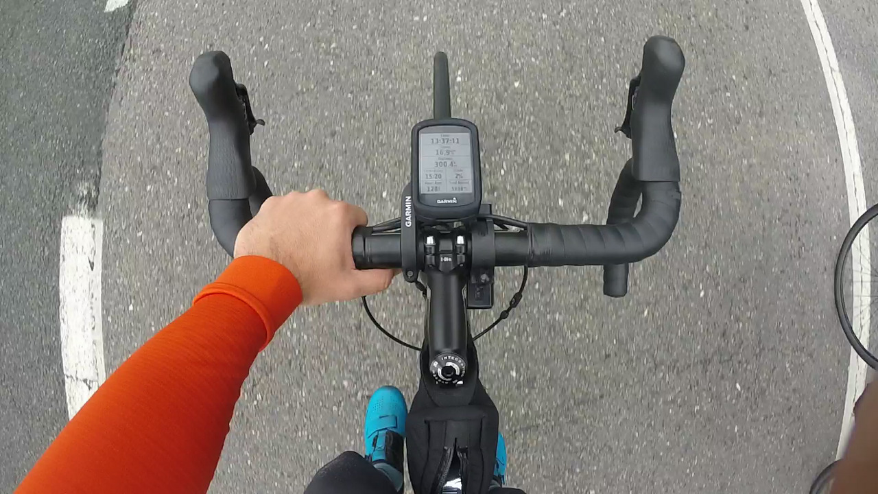 A picture of my bike's handlebar, left hand on it. The Garmin is showing 300km, 13 hours and 37 minutes moving time.