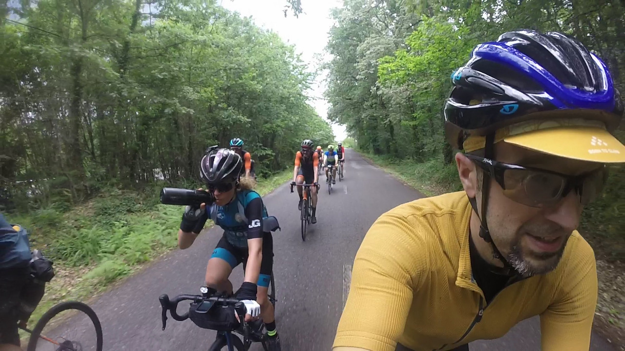 The group, riding on a road surrounded by trees