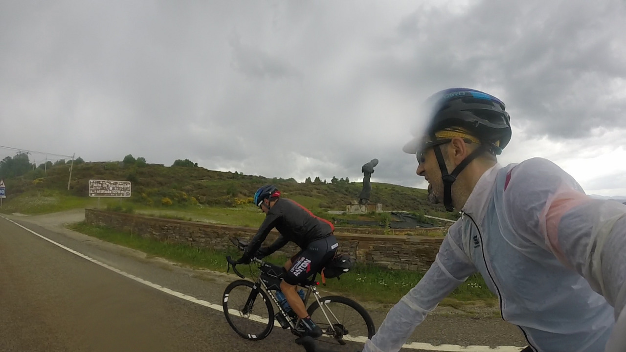 Me and Roberto, passing by the statue of the pilgrim at the top of alto de san roque
