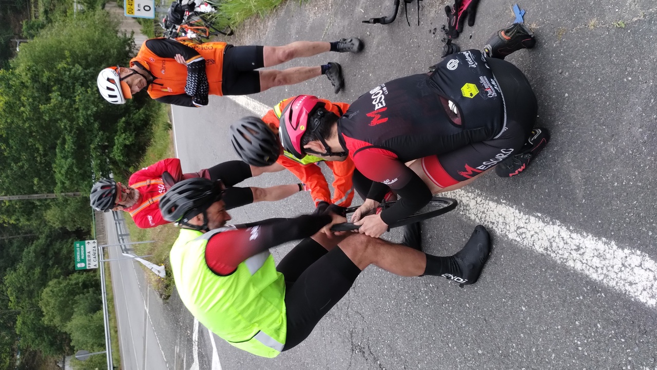 Dani, Jose and Angel trying to put the tire back on the rim, while Edgar and Graeme look at them