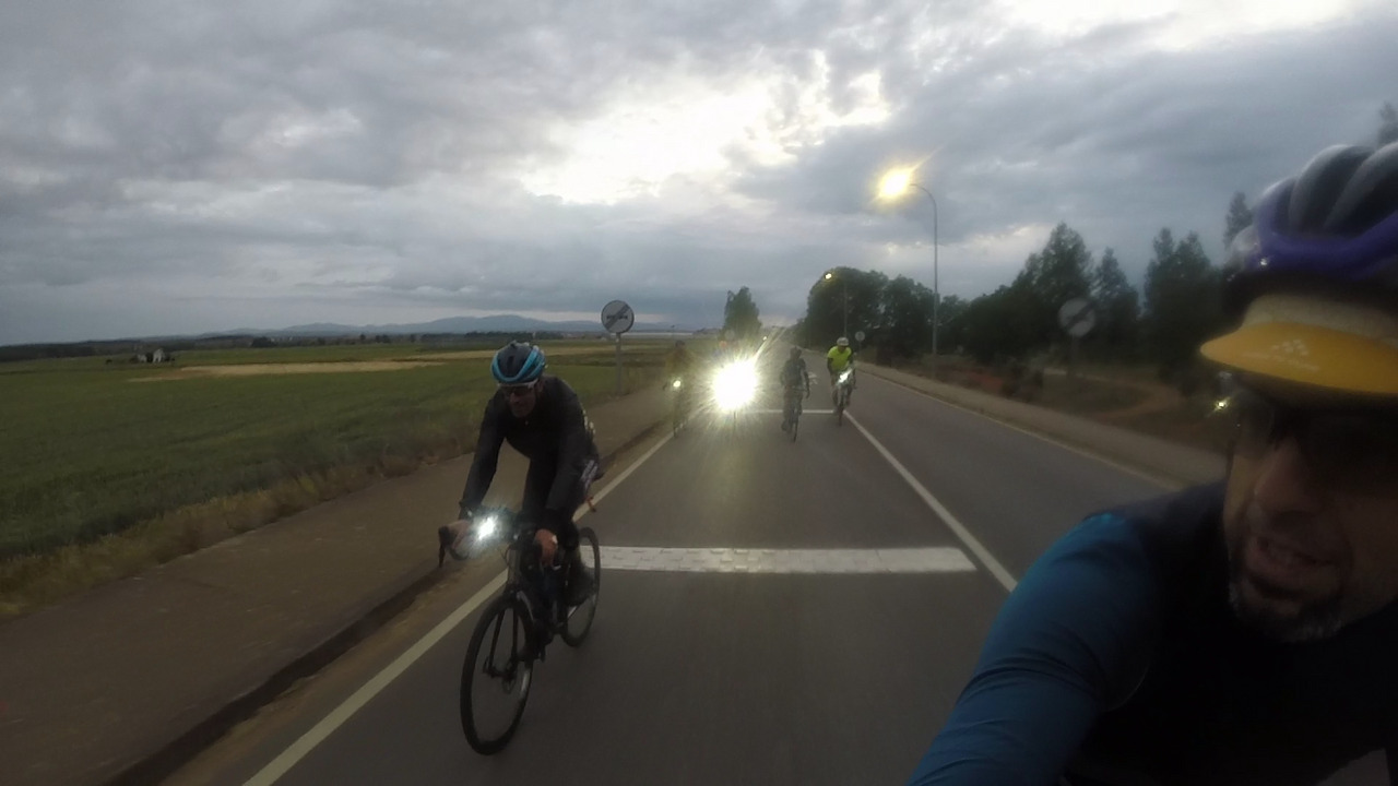Roberto and the others, front lights on, chasing me on our way into San Justo de la Vega
