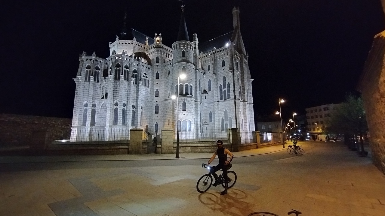 Me, posing with the bike in front of the 'Palacio de Gaudi' at night
