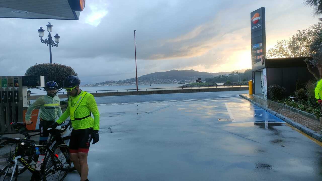 Me and Oscar, by the gas station where we did our stamp stop in Baiona, the sun was rising from behind some hills in the horizon