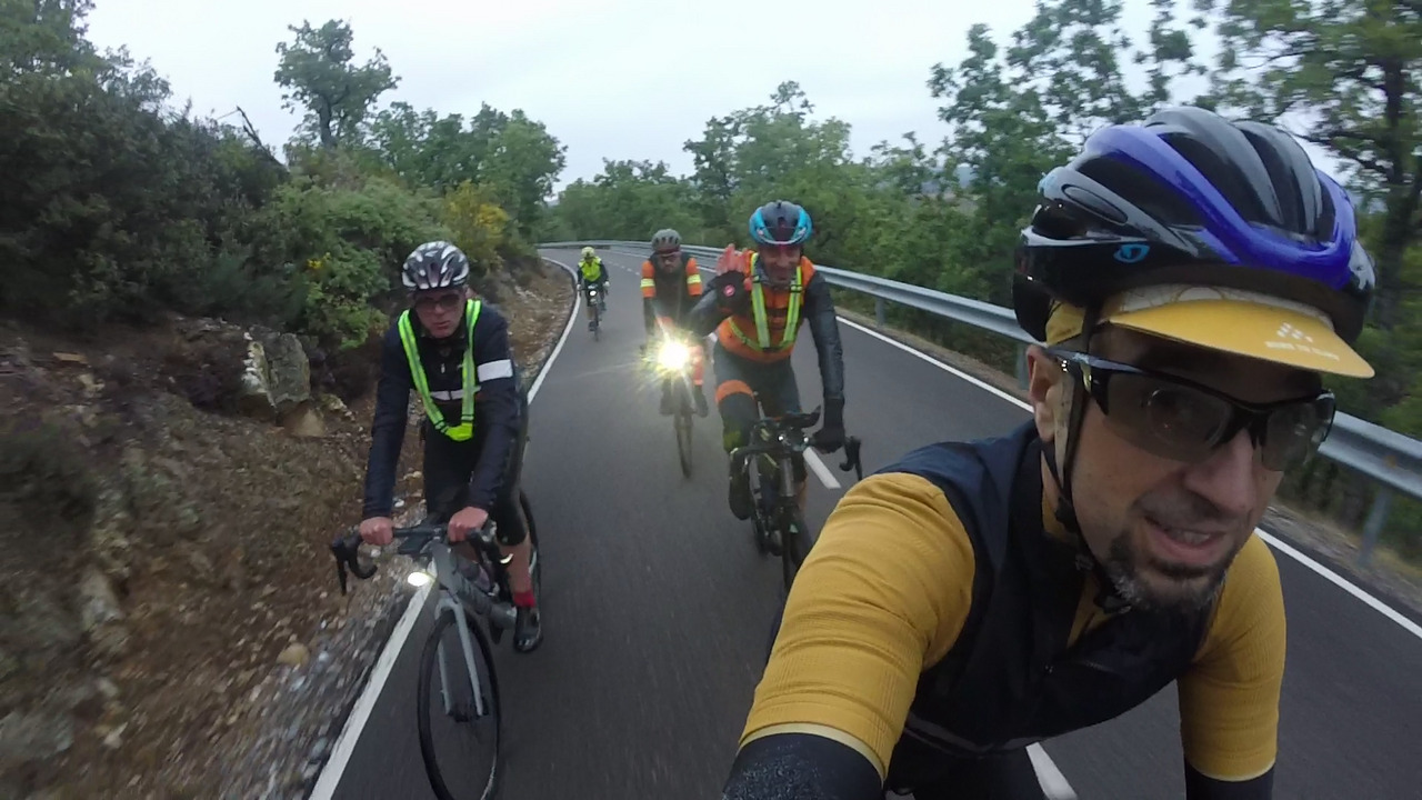 Juankar, Manolo, Sergio, Roberto - waving at the camera - and me, on a smooth road towards Foncebadón