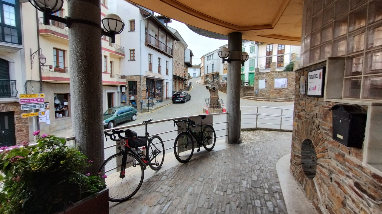 Our bikes leaning on some metal barrier on the terrace where we had our coffee stop. On the back of the photo you can see the crossroads from the previous picture, from the opposite side