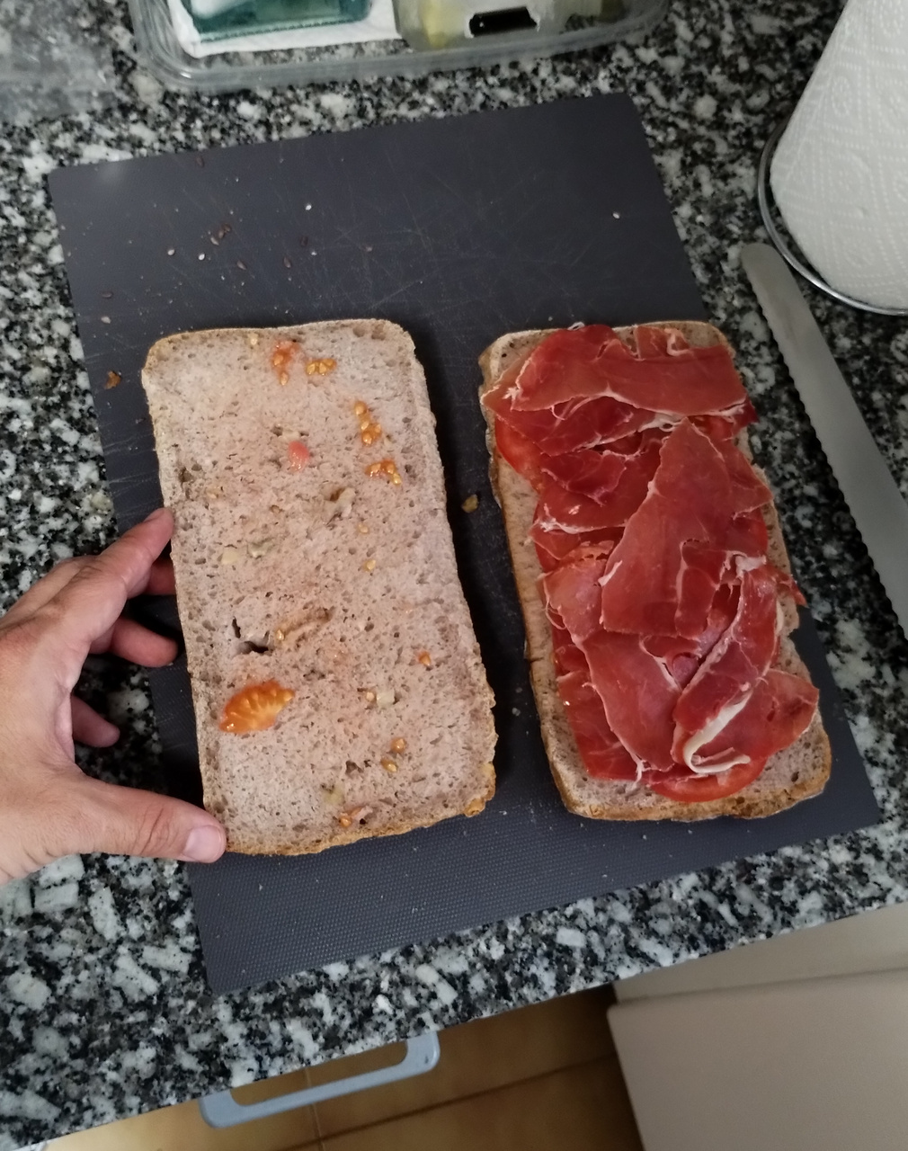 A picture of the 'bocadillo de jamon' I prepared to bring with me during the brevet, before 'closing' and slicing it into smaller pieces. My hand appears on the picture to use as measurement of the size of the bread.