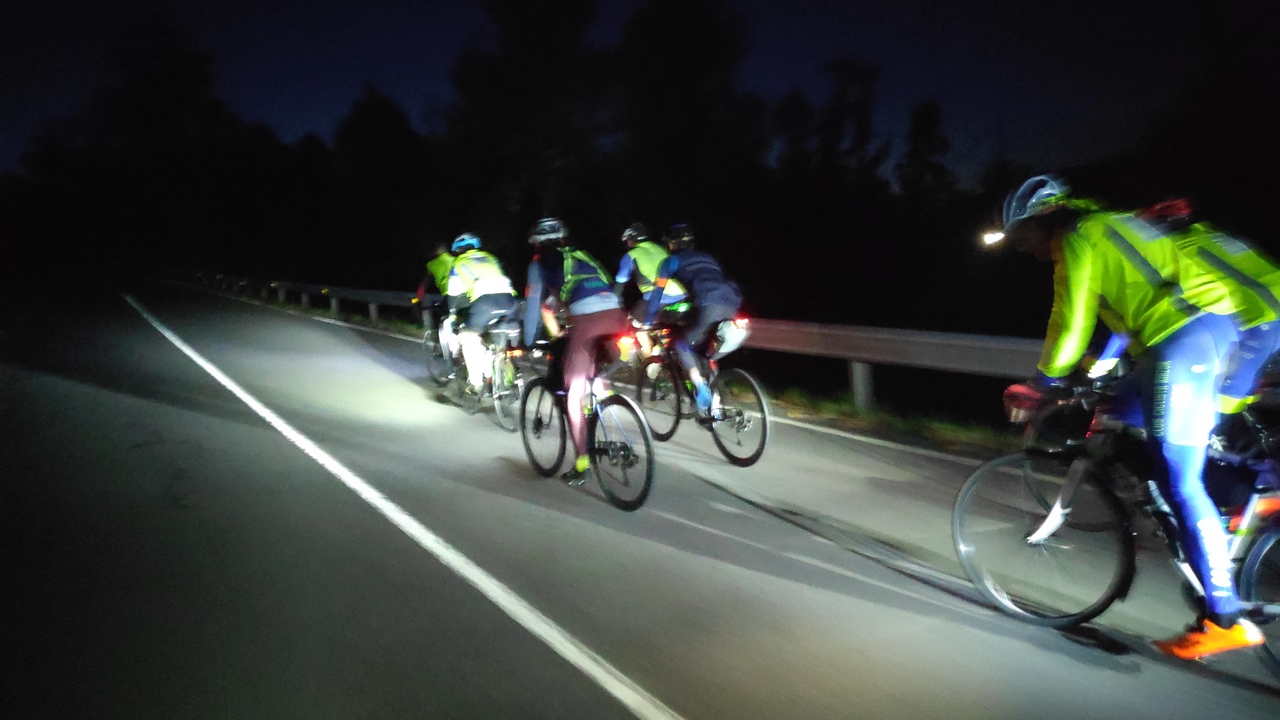 A group of randonneurs, riding up the first climb of the Brevet, in the middle of the night