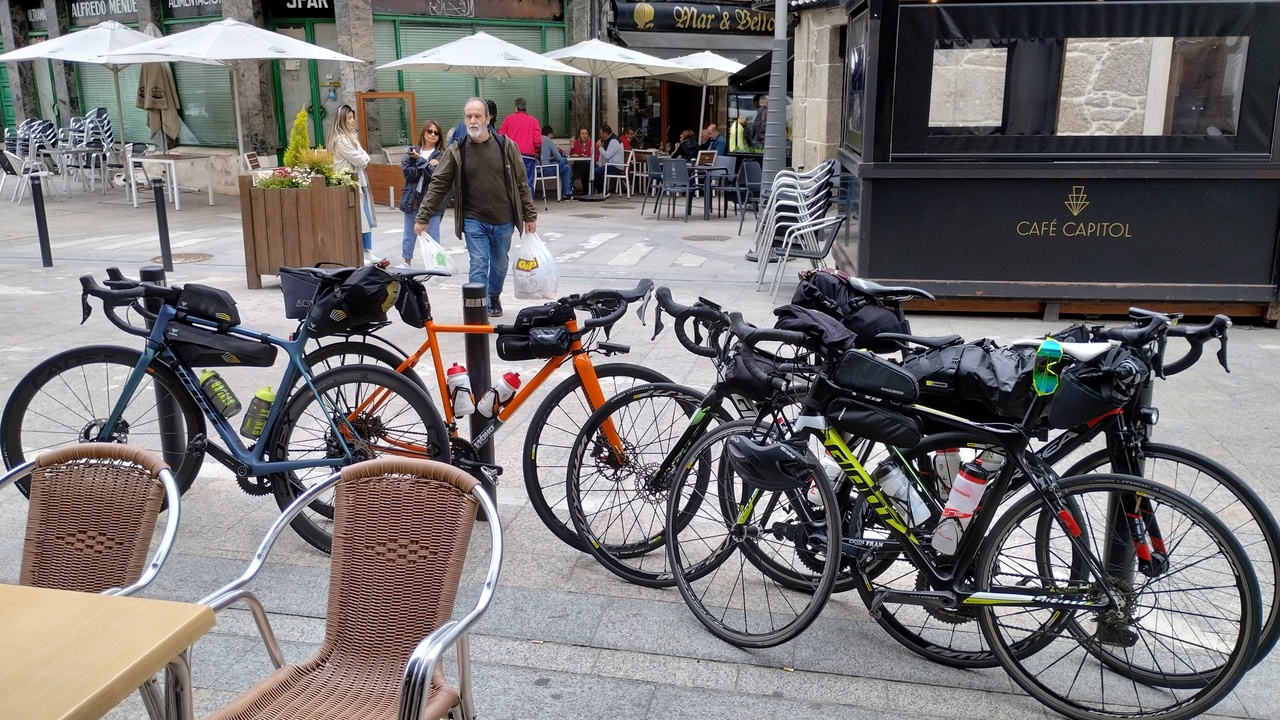 Several of our bikes, parked outside the bar Parada in Chantada