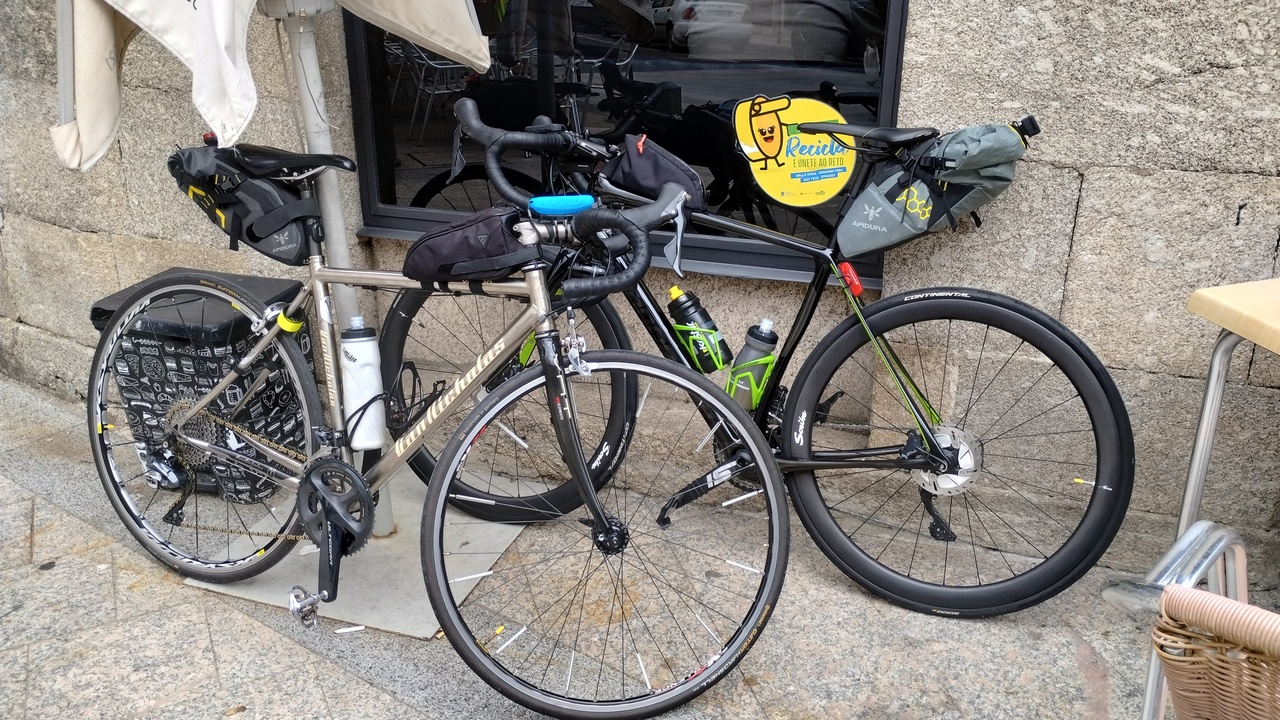 Manolo's Van Nicholas tailor-made titanium bike and my cannondale synapse, parked outside the bar Parada in Chantada