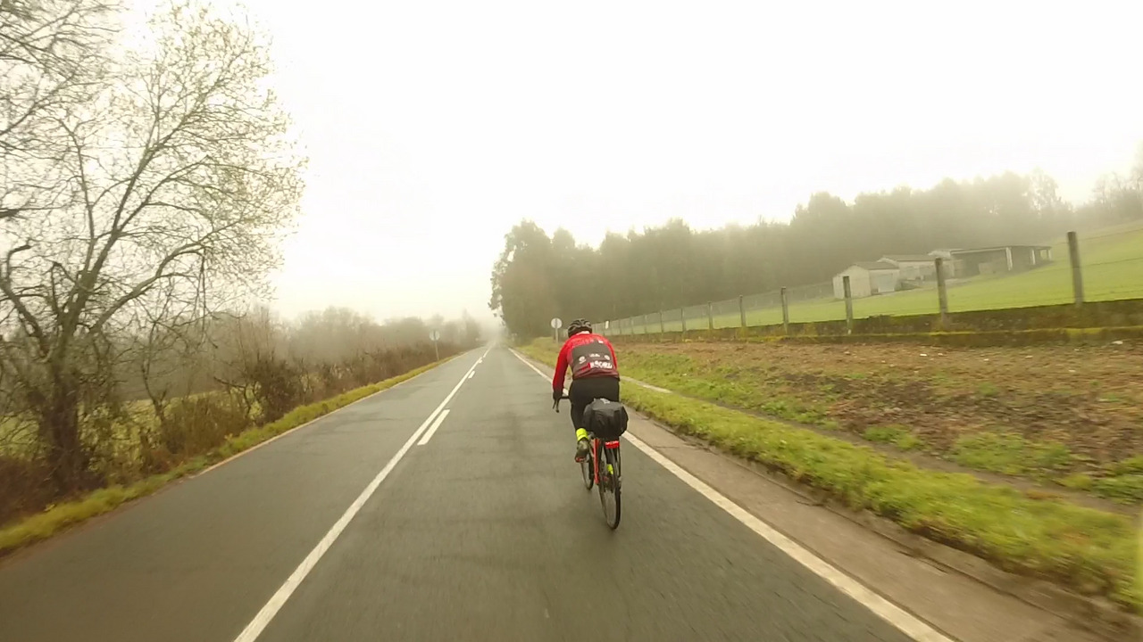 Edgar riding his steel bike through the fog, moments before dropping me