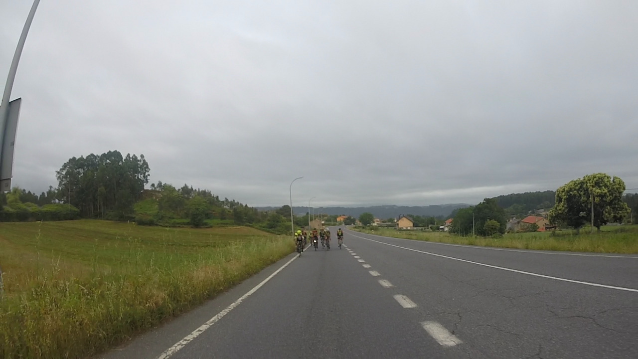 A bigger group, chasing me up the climb passing by Coirós