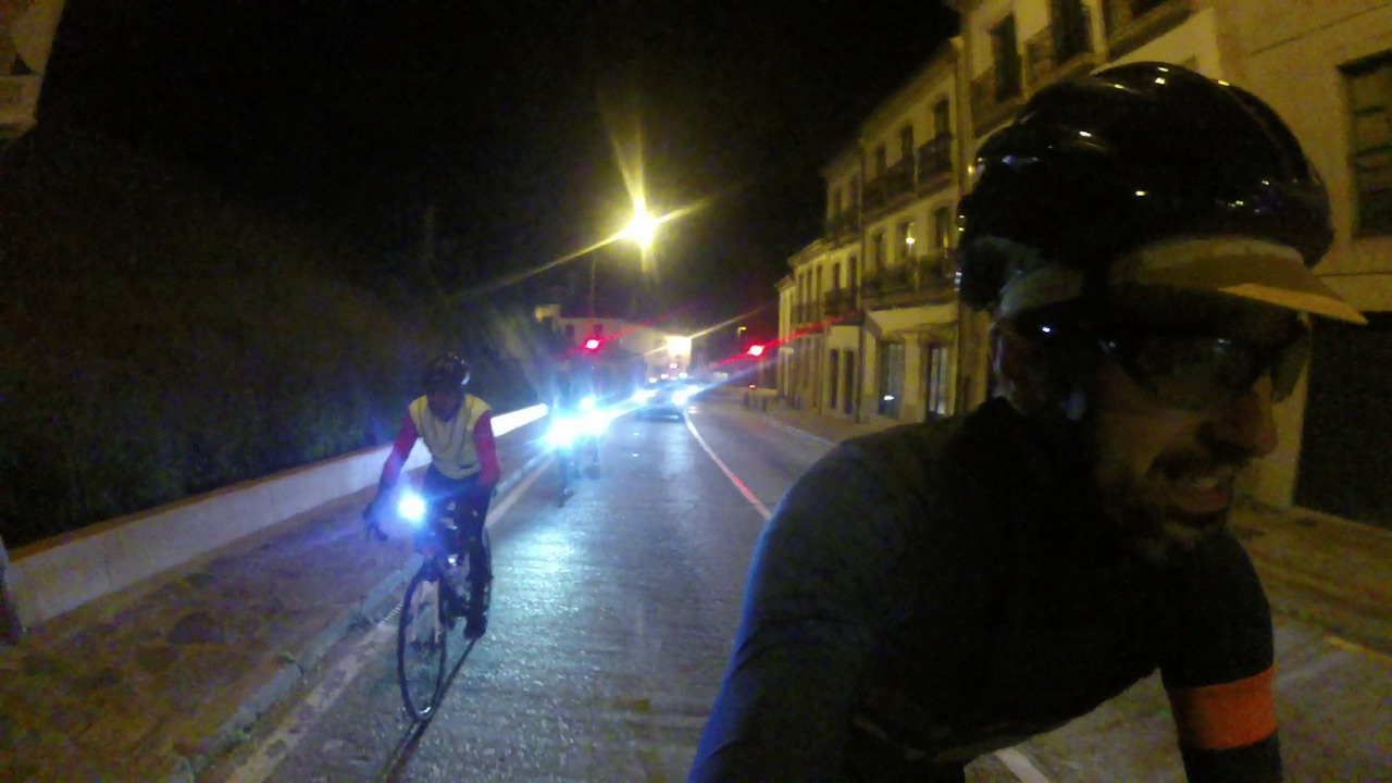 Me, being chased by Jose and a few head lights, on an old street in Santiago. A car is also coming behind us, a couple of red traffic lights at the back of the picture look like two bright red eyes. A big street lamp shines with a bright yellow light, giving the picture a yellowesque color