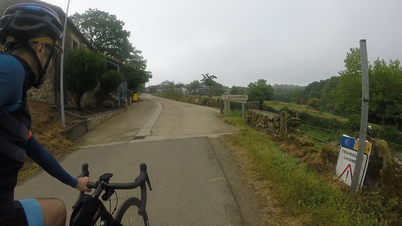 Myself, at the entrance of Ligonde, passing by the sign with the name of the village