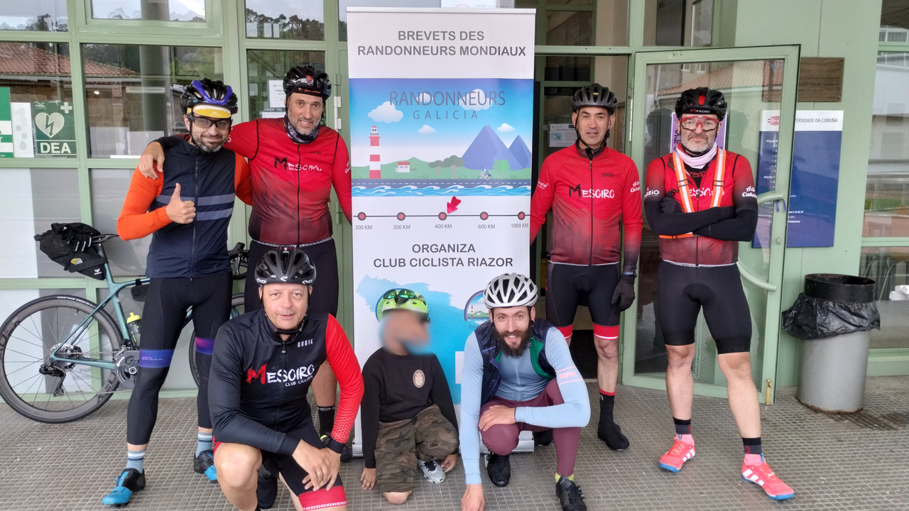 A picture of our little group of randonneurs, the 'Mesoiros', Alex, me and Jose's Son, posing by the big flyer made for this Brevet