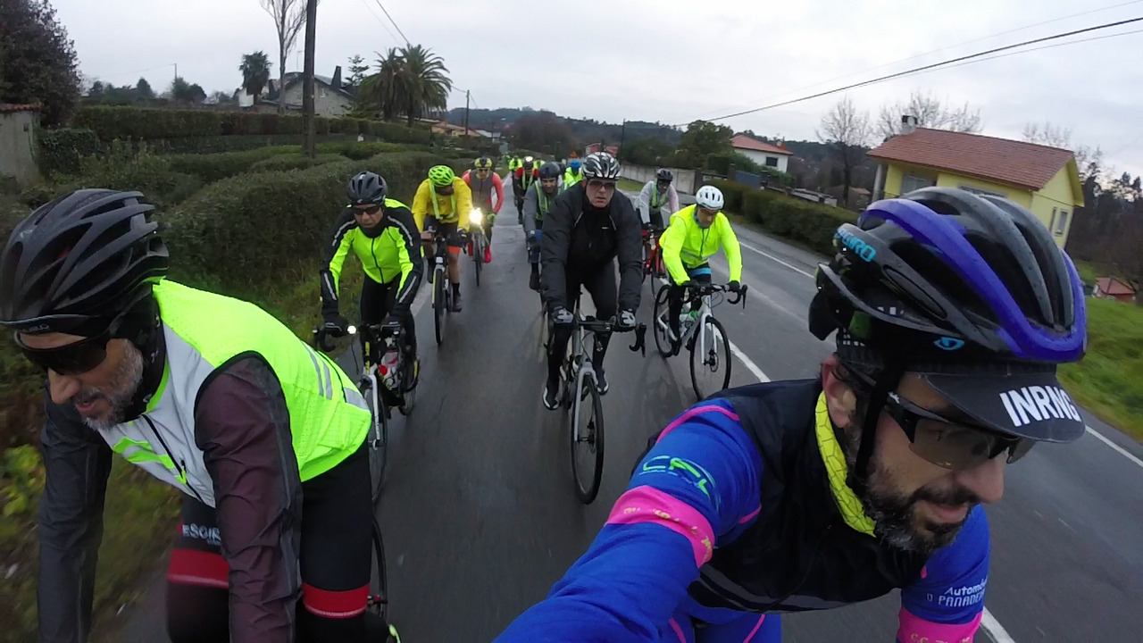 The main group of riders, early in the Brevet, riding on a wet road