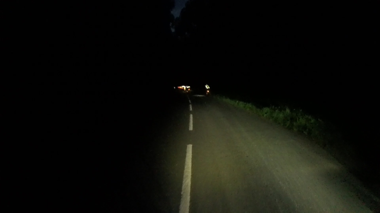 A line of tail lights far ahead myself, riding in total darkness