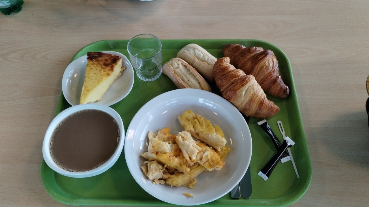 My breakfast at the restaurant in Fougerès on Monday morning, cafe au lait, a couple croissants, two pieces of bread, a french omelette and something that looked like cheese cake