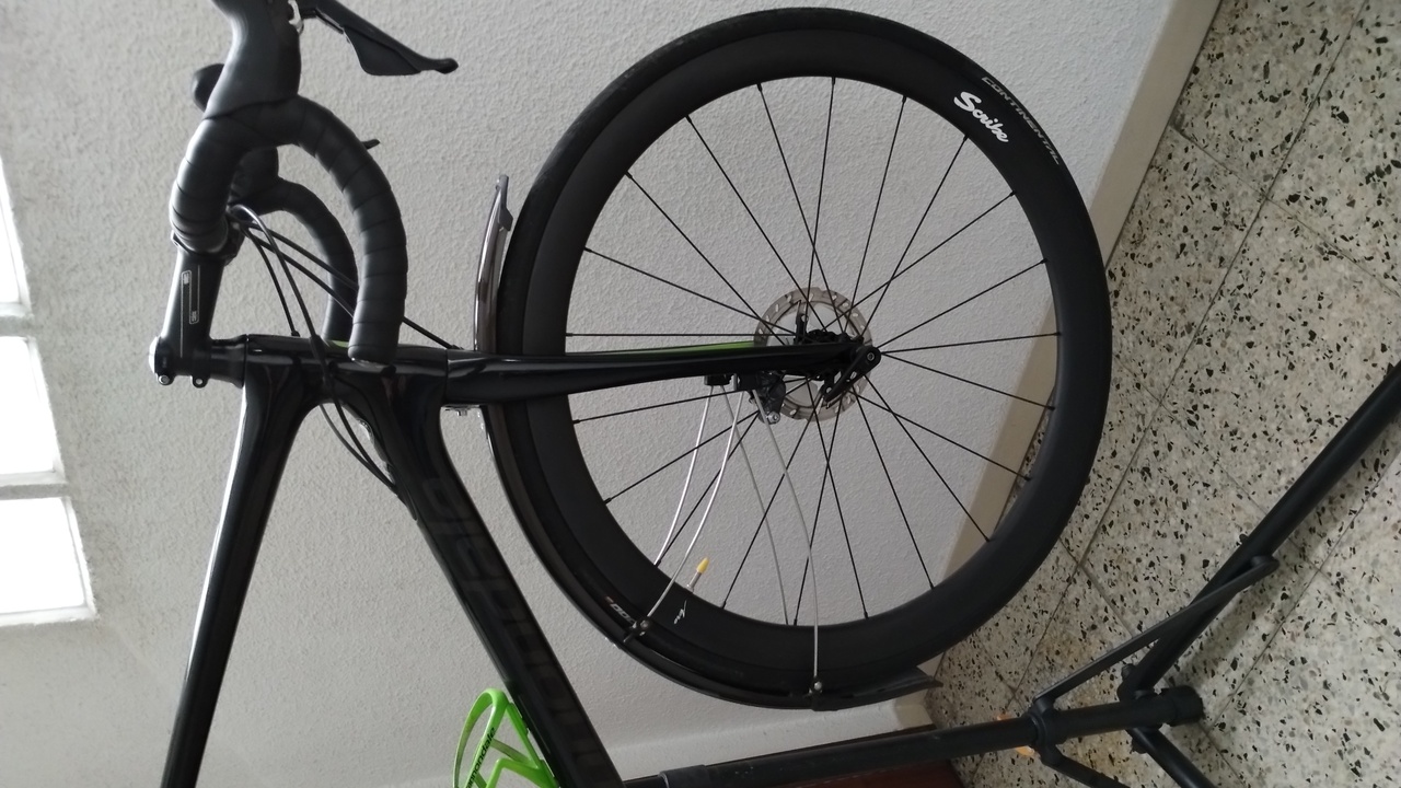 A close-up of the front fender, viewed from the right side of the bike
