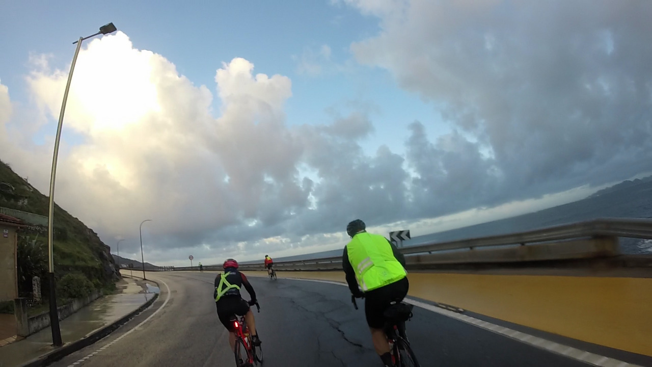 Ángel, Jose and Dani, taking a turn left on the coastal road from Baiona to Santa Trega