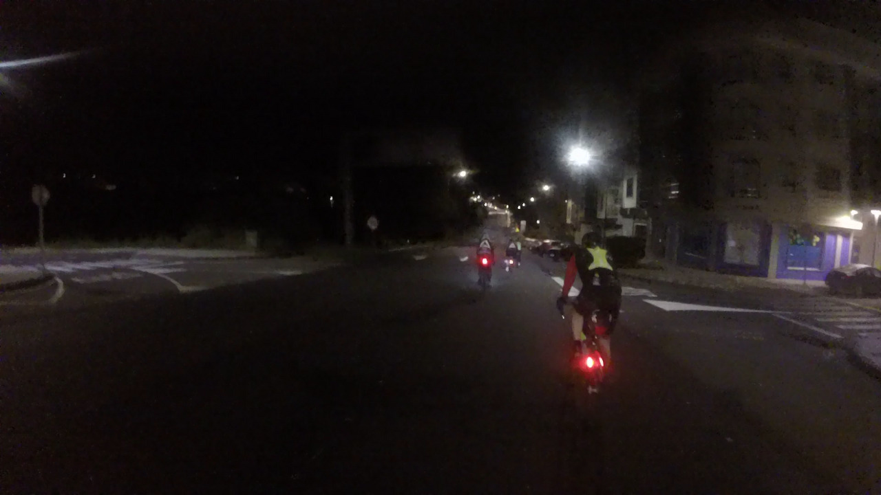 Our little group of randonneurs, leaving the town of Lalin, riding on a long avenue that goes down first, then starts to go up slowly