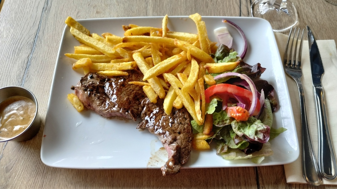 My main lunch, a delicious piece of meat with salad and potatoes