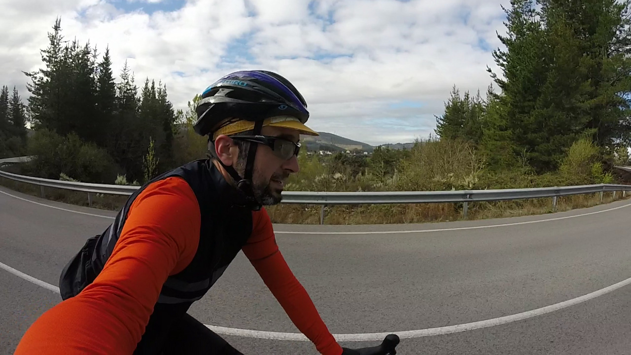 Me on the short climb after Toreno, the photo was taken from my right side, there are tall trees behind me and the wide angle of the gopro shows the road as circle, as I was doing a long turn.