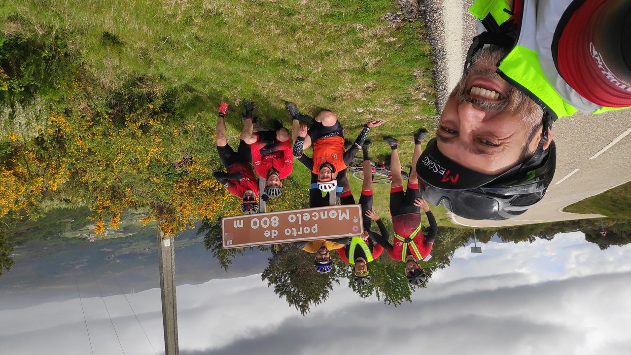 Group picture by the sign of Porto de Moncelo, at the top of the longest climb of the day