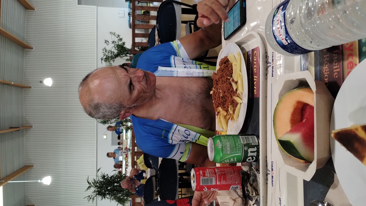 Manolo, with a big plate of pasta bolognese, a coke and a beer in front of him, he was checking on the phone the status of some of their friends and colleages