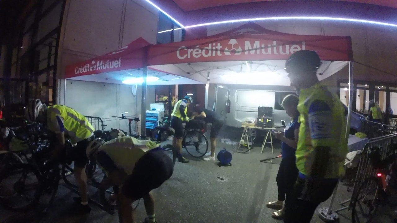 Ferreiro and his bike, with a mechanic looking into its rear wheel. Dani is waiting while a couple more randonneurs are looking into another bike