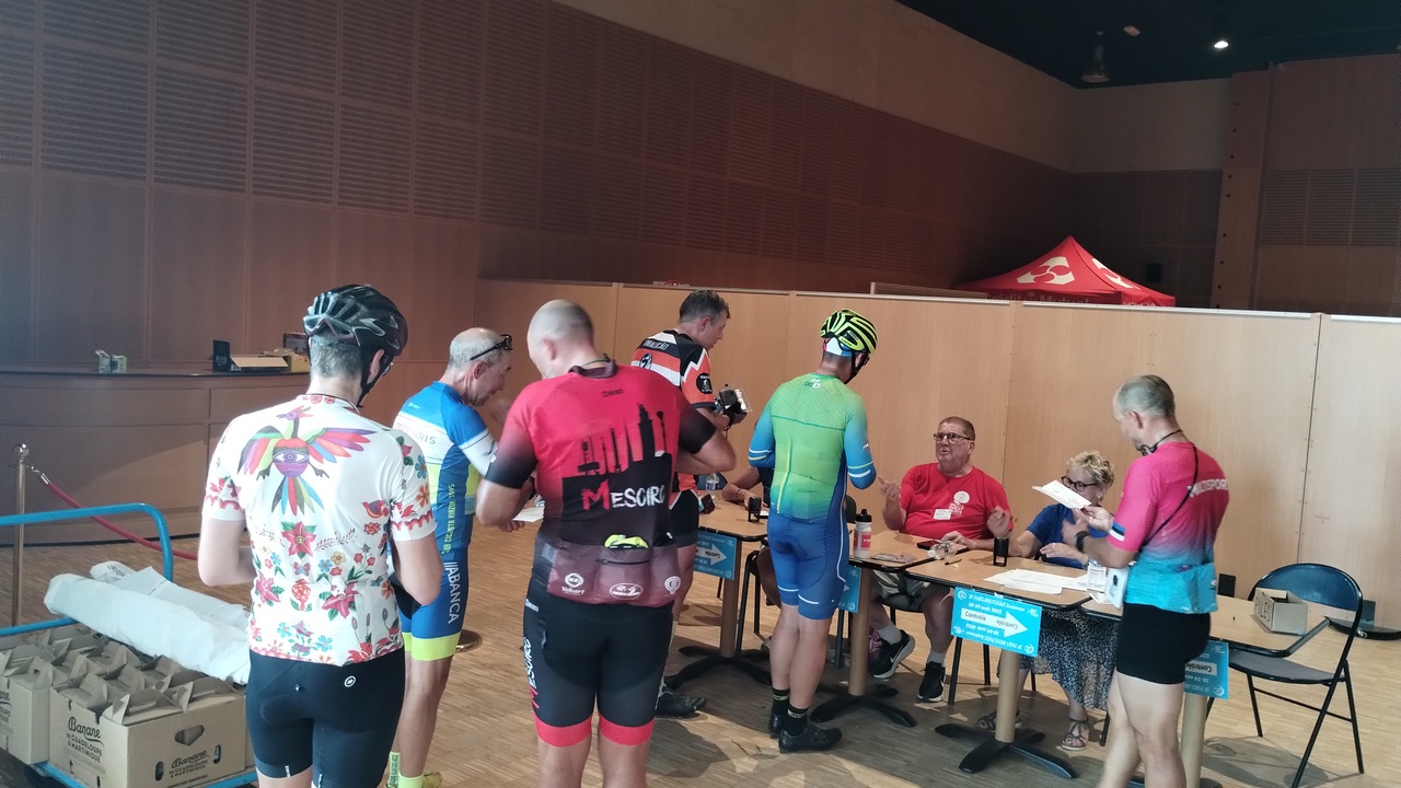 Dani and Felipe waiting in line with other randonneurs to get their stamps in Mortagne au Perche