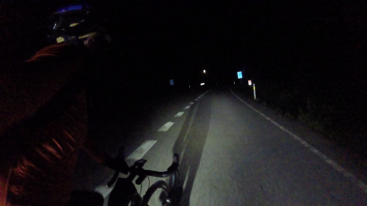 Myself, riding towards the moon. One of the headlights behind me is so powerful it projects a big shadow of myself and the bike on the road