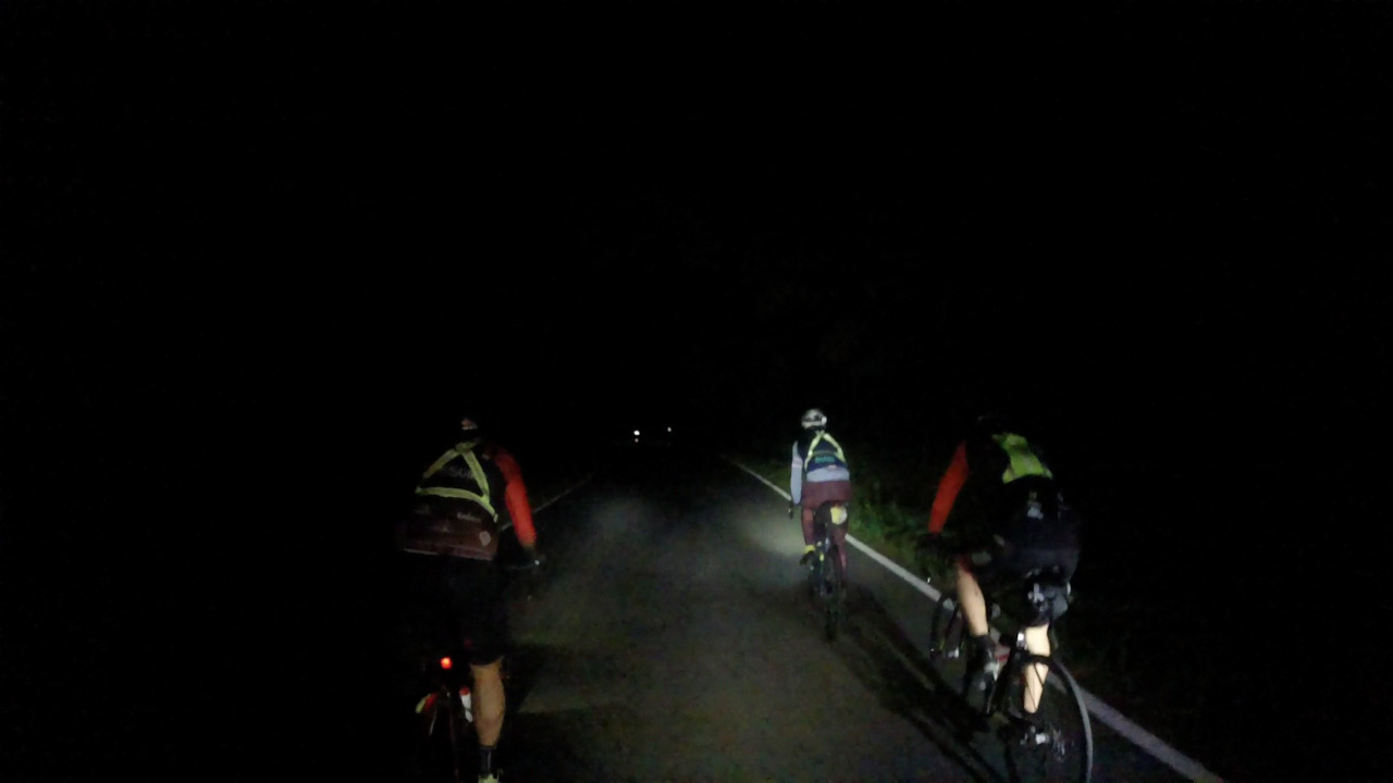 Dani, Alex and Óscar riding in the dark. Their head lights and mine combined make the road a bit more visible
