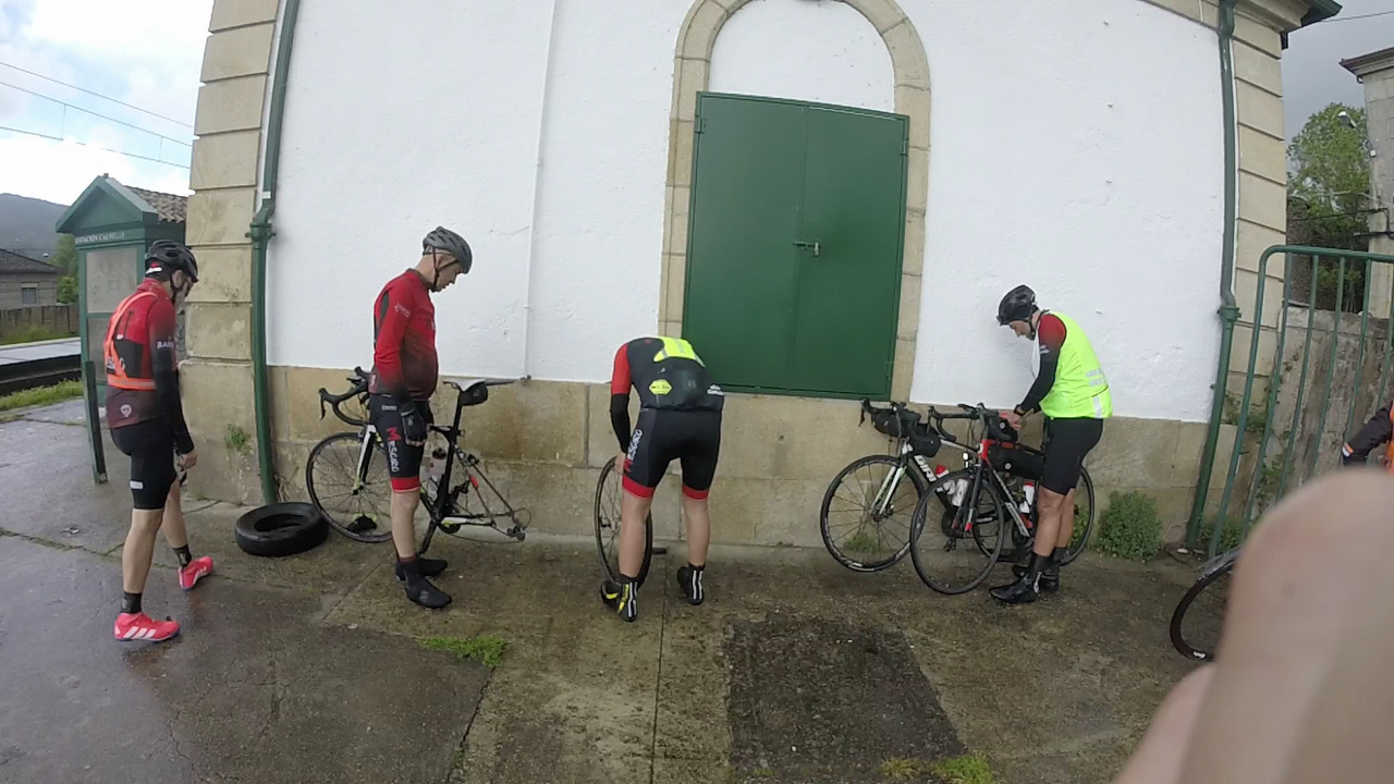 Mesoiros at work, with Oscar fixing his rear flat tire and the others helping him