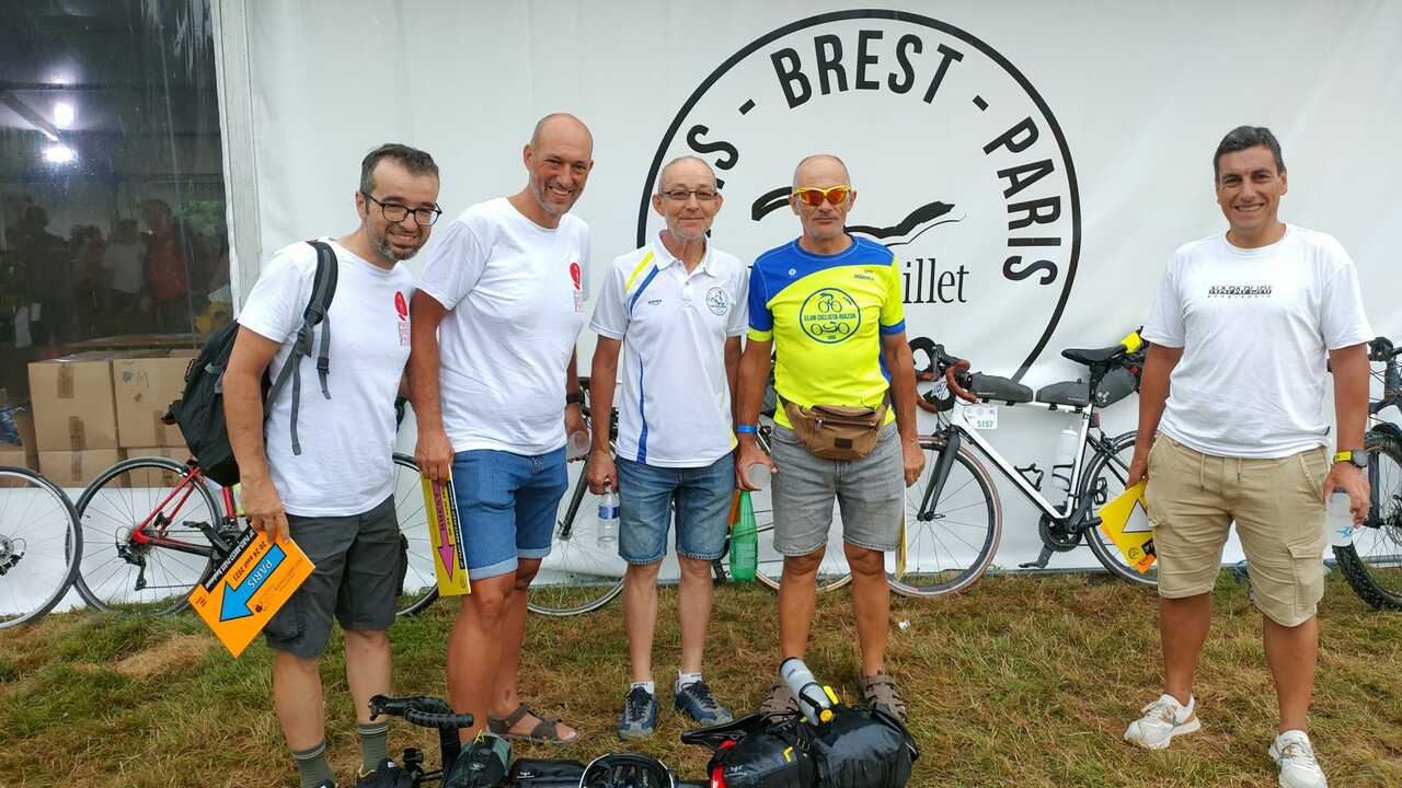 The Galician Expedition (without Luis), posing in front of the Paris-Brest-Paris Rambouillet logo outside one of the tents