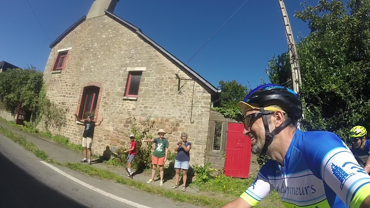 Another family, cheering riders up in front of their house