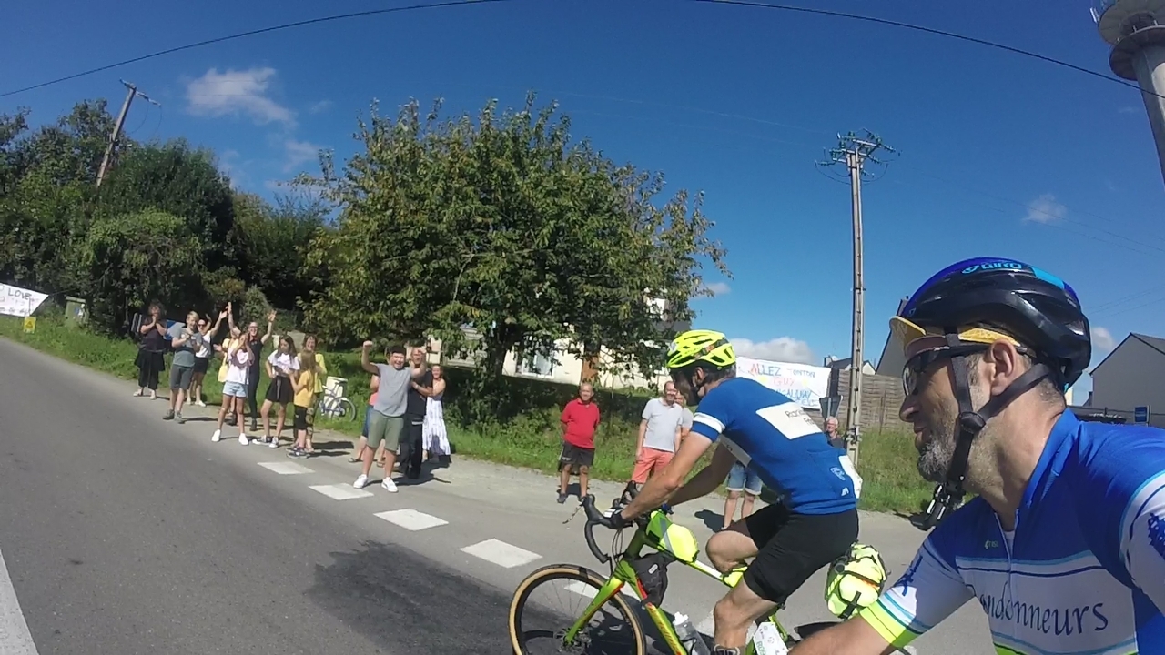 Still riding with the guy from Finland, a big group of people was cheering us up on our way up a little hill