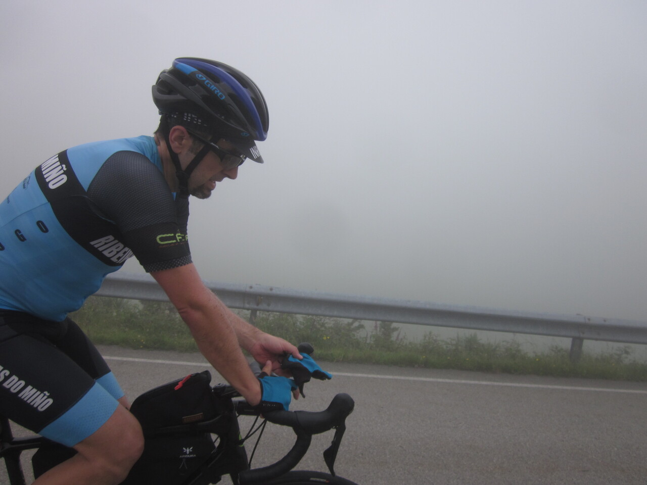 Me, surrounded by thick fog, putting my fingerless gloves back on.