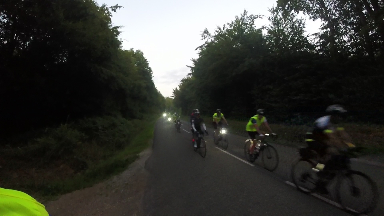 Several riders in a fast group, passing by us while we were putting our reflective vests on