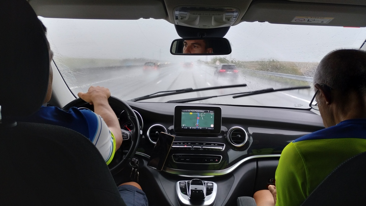 Picture taken from inside the van, Ferreiro is driving, Manolo being the copilot, outside water is pouring down.