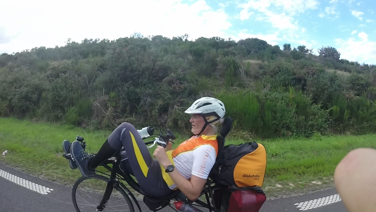 An old guy, riding a recumbent bike