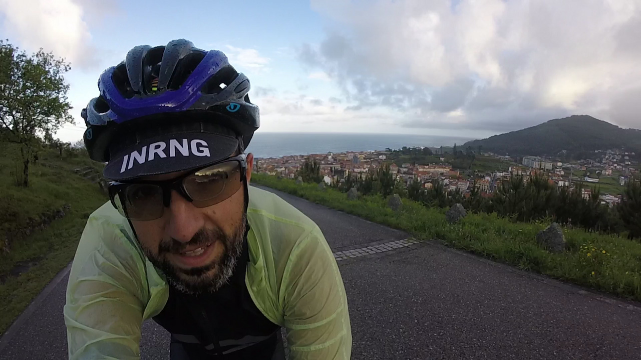 Selfie of me going up to Santa Trega, with a nice view of the village of A Guarda down below and the Atlantic Ocean behind it