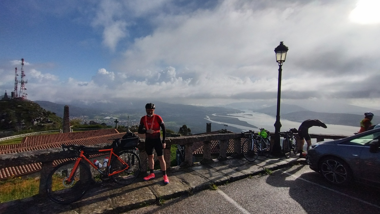 Edgar, posing with his bike for a photo with a nice view from the top of Santa Trega