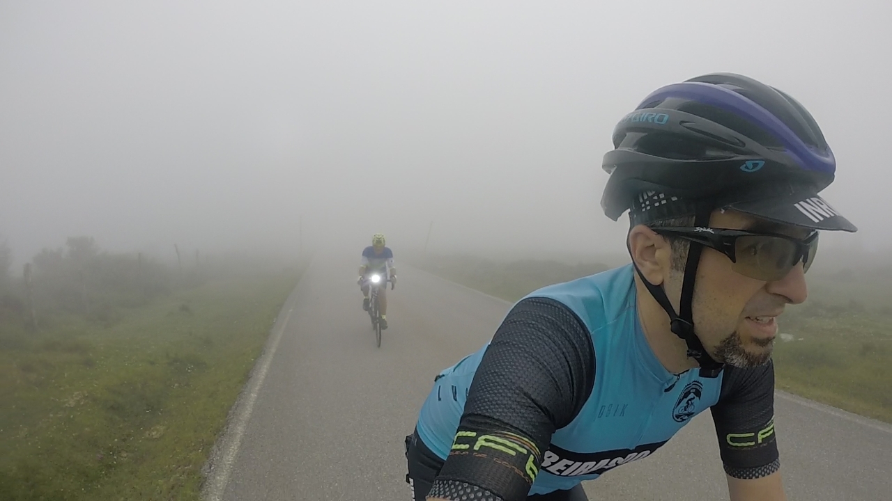 Manolo riding behind me, through the clouds, head light on