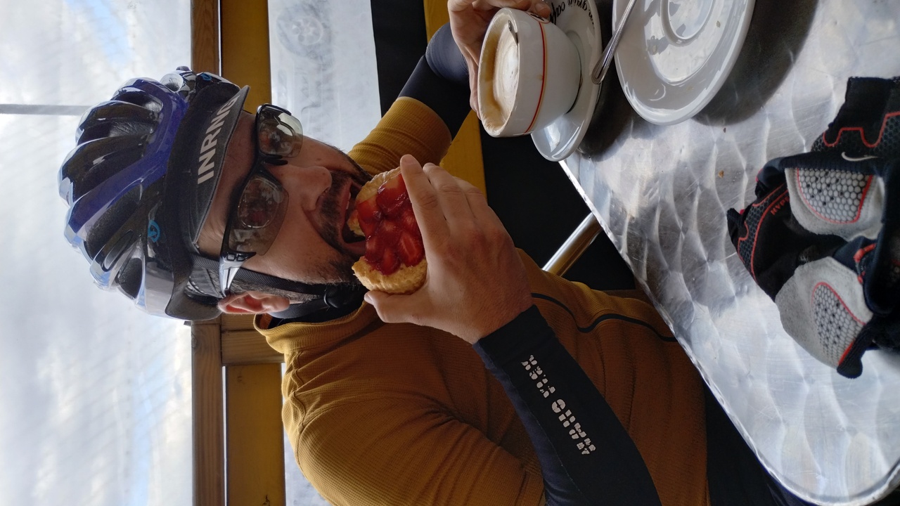 Me, eating a big cake and a huge cup of coffee while seating in a terrace in Celanova