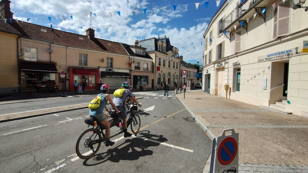 A couple, riding a tandem on one of the streets in Rambouillet