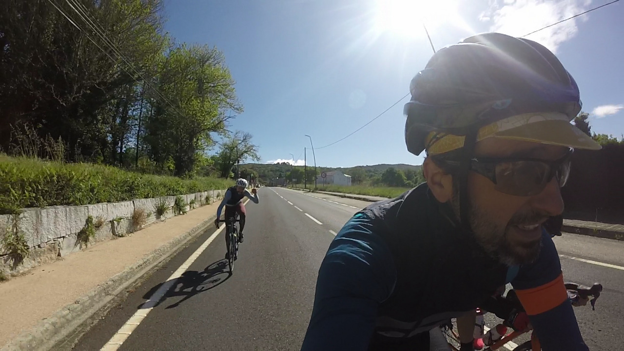 A happy Alex, left fist up, going down the main road from Alto do Couso