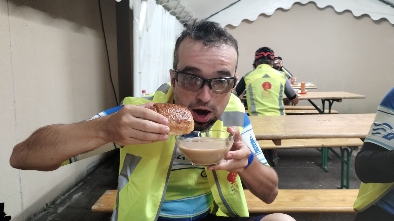 Me, done with my own bocadillo, about to start eating a pain au chocolat and a huge cup of coffee