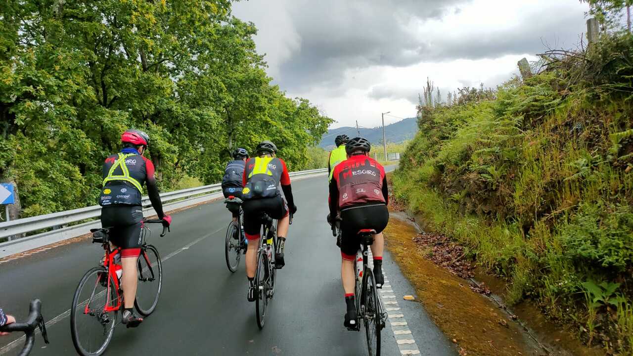 The full group, riding on a wet road (photo taken from behind)