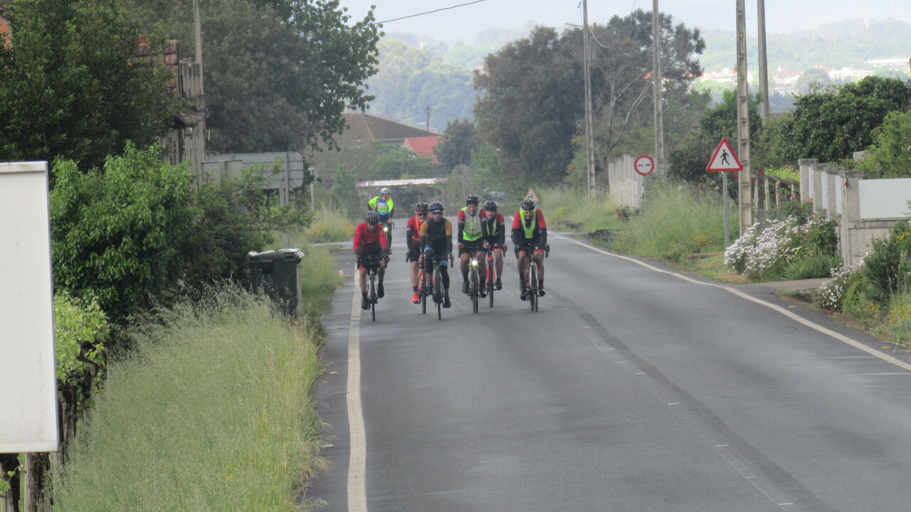 Another pic of the whole group, riding on a wet road. The picture was taken by the photographer with the pro camera, from quite some distance